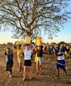 Guests from Norway fetching water in Kobulin village, Alakara Guest House, Uganda