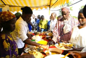 Traditional Ugandan celebration buffet with rice, matooke, chapati, and meat dishes