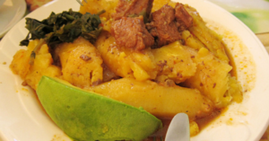 Boiled matooke bananas, a staple of Ugandan cuisine, with avocado, greens and meat